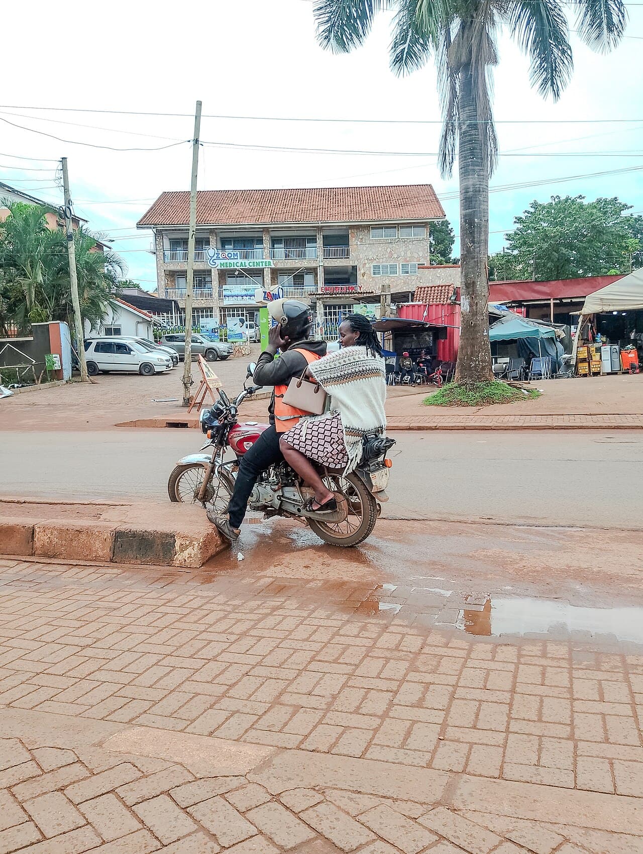 A boda boda rider preparing to carry a passenger in Kabalagala, Kampala