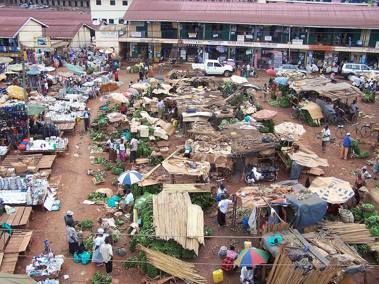 A busy open-air market in Kampala with traders and shoppers