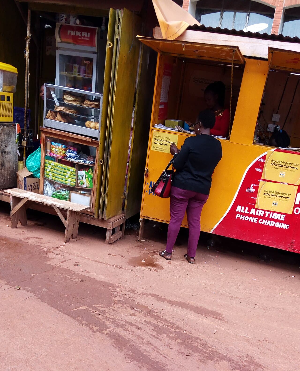 A woman attending a mobile money kiosk